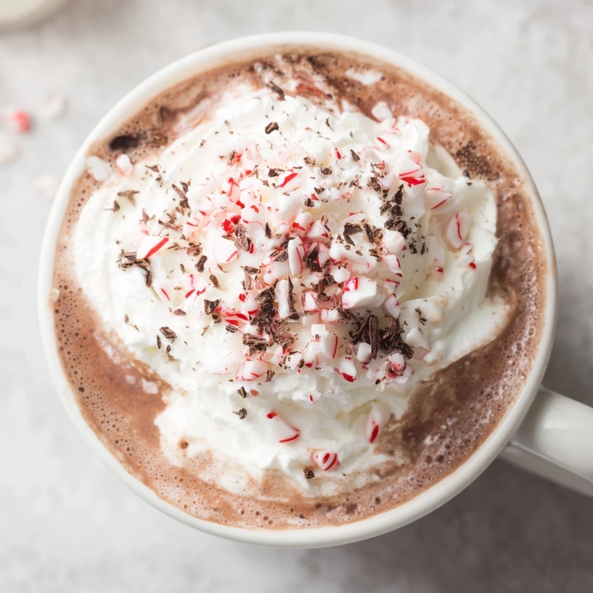 Rich and chocolatey peppermint hot cocoa, topped with crushed candy canes, a delightful winter treat.