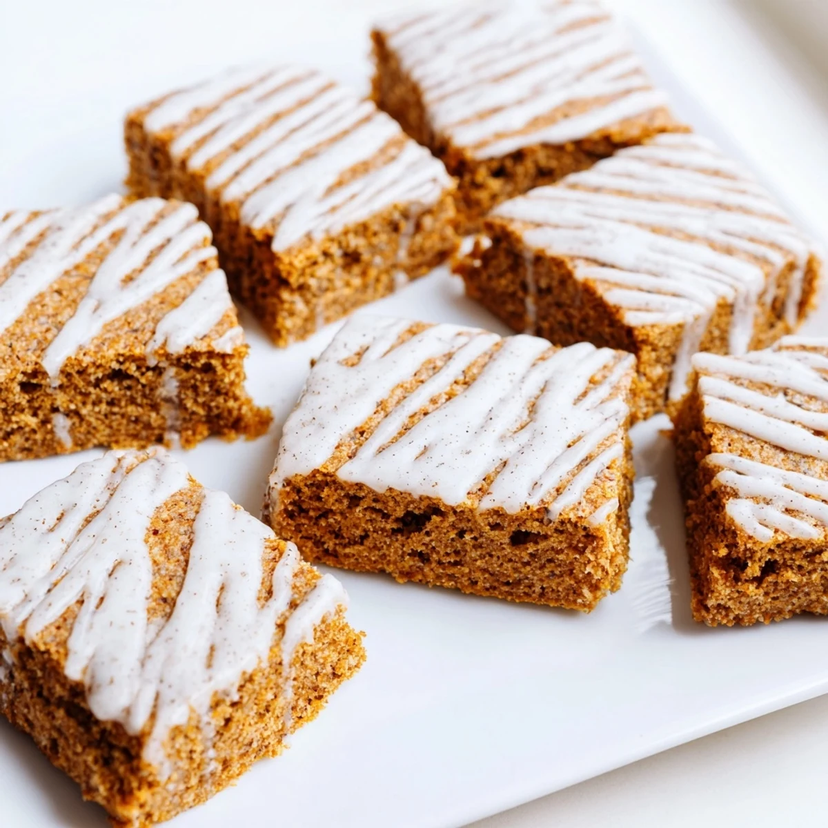 Perfectly frosted gingerbread cookie bars arranged for serving, promising a taste of holiday bliss.
