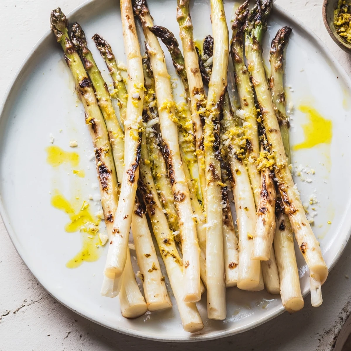 Freshly zested lemon over perfectly roasted asparagus, a healthy and flavorful meal option.