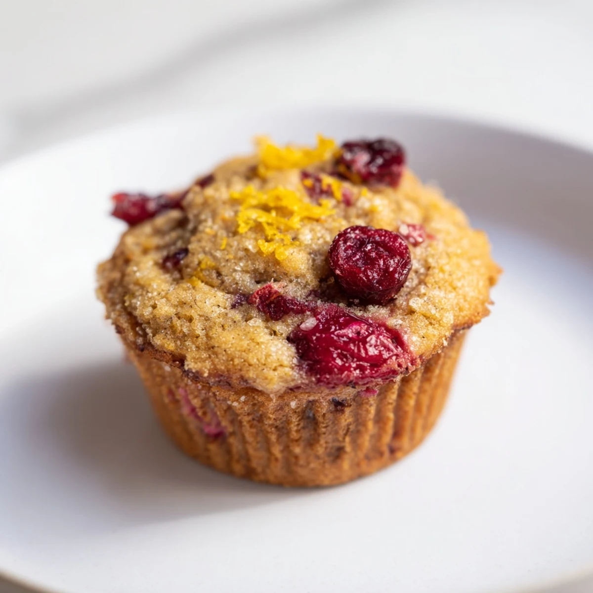Warm, appetizing cranberry muffins, served with butter ready to enjoy in a home kitchen.