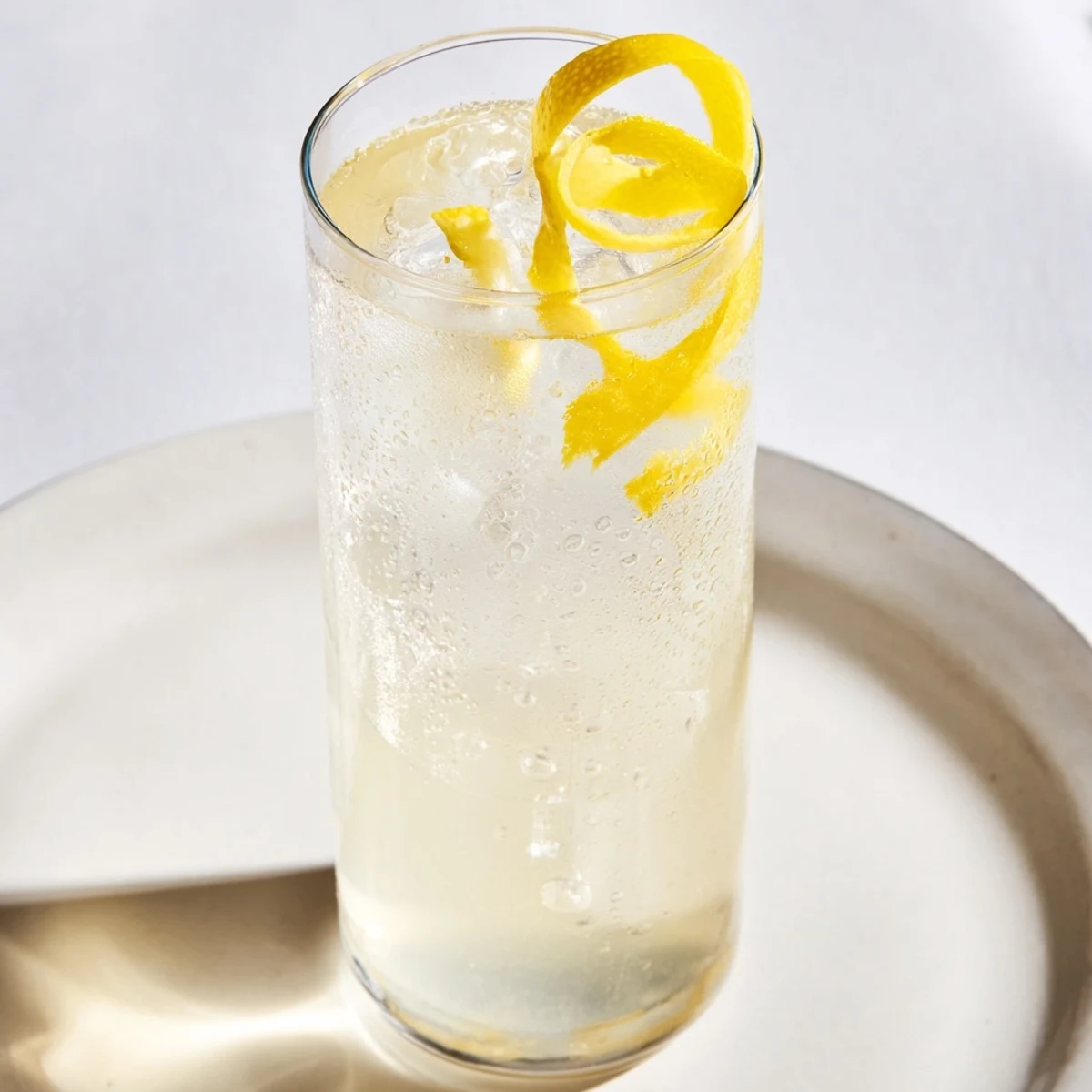 Sparkling water fizzing in a glass with fresh Twist of Lemon, ideal for a hot day.