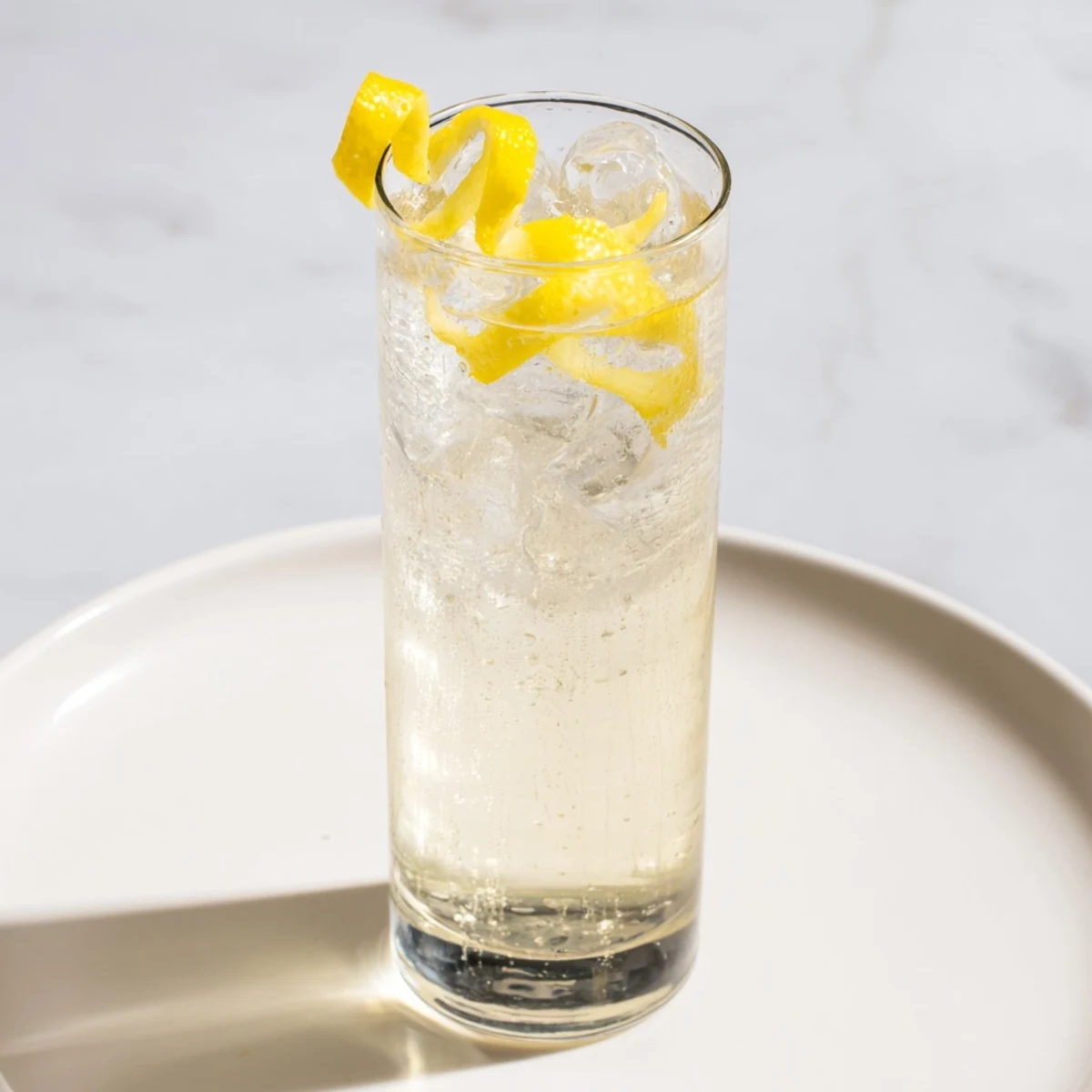 Close-up of a vibrant Twist of Lemon mocktail, garnished with a citrus twist, ready to enjoy.