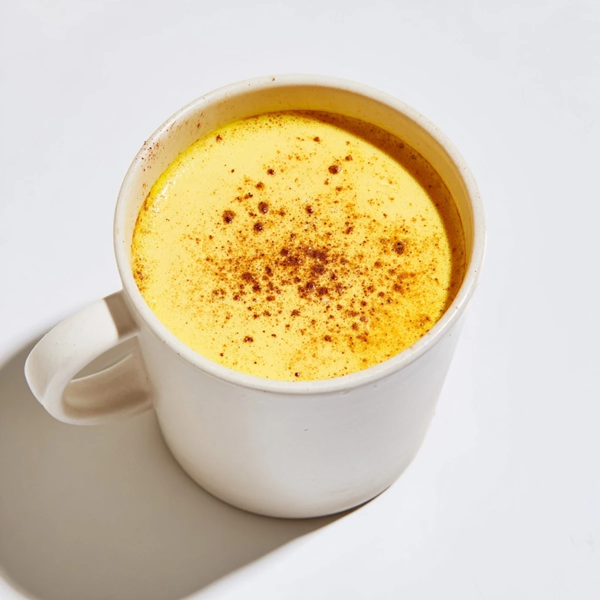 Steaming mugs of Spiced Golden Milk, a creamy and aromatic Indian-inspired beverage, ready to savor.
