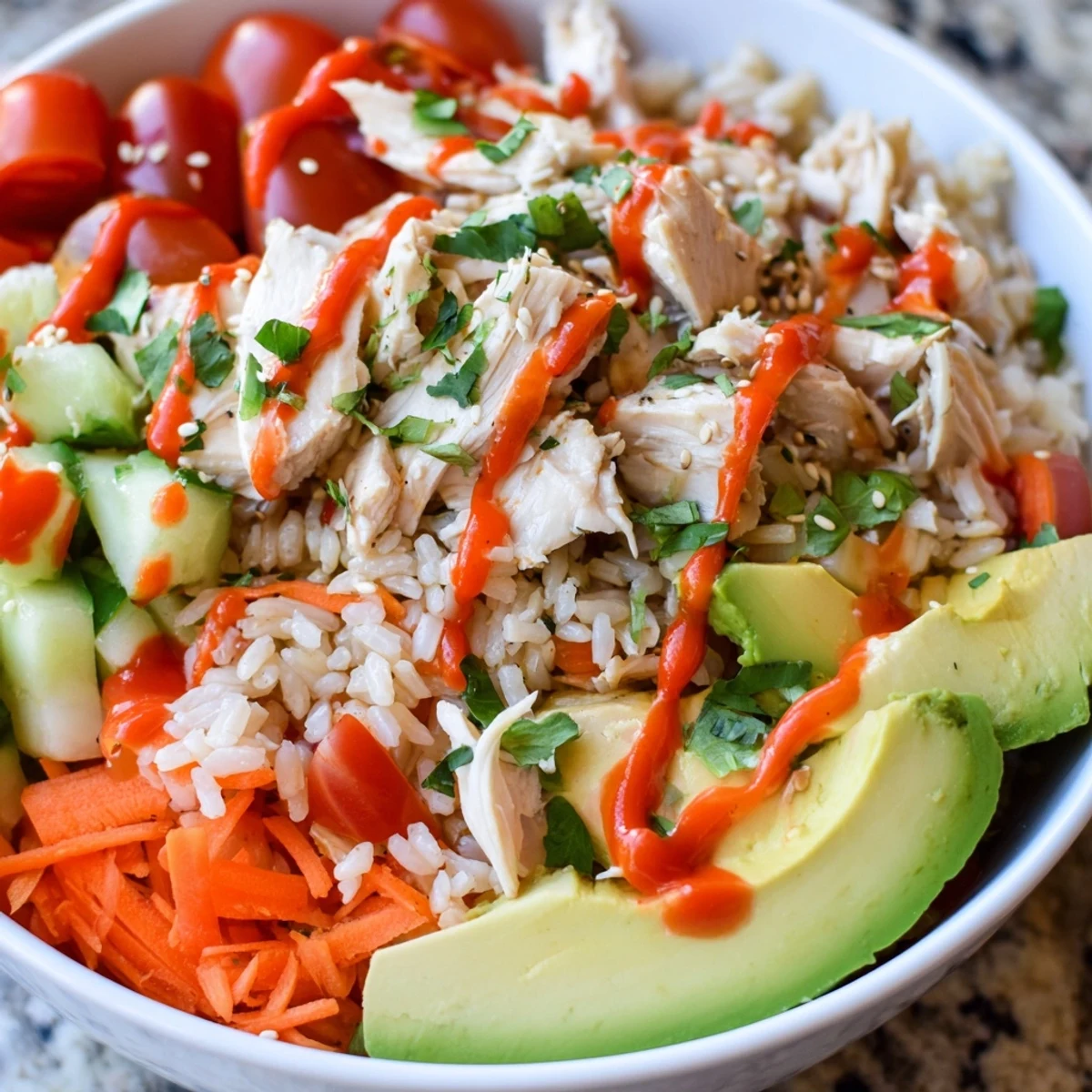 Spicy Lunch Bowl features juicy, paprika-dusted chicken, vibrant veggies, and creamy avocado over fluffy brown rice.