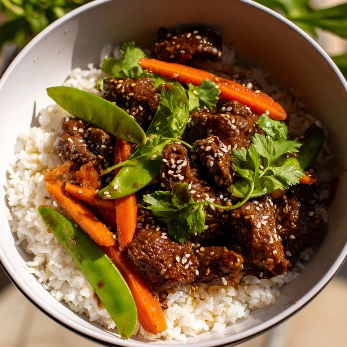 This hearty Beef Lunch Bowl garnished with green onions and sesame seeds promises a satisfying midday meal with irresistible aromas.
