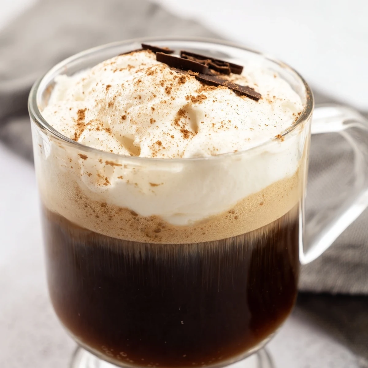 Steaming Irish Coffee Mocktail in a mug, perfect for a cozy afternoon with a buttery cookie on the side.