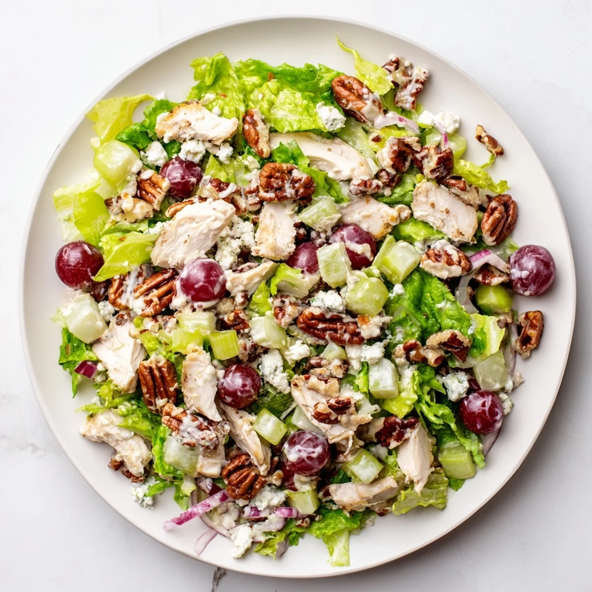 Fresh mixed greens, savory chicken, and buttery pecans shine in this easy Chicken Pecan Salad, finished with a luscious creamy dressing.