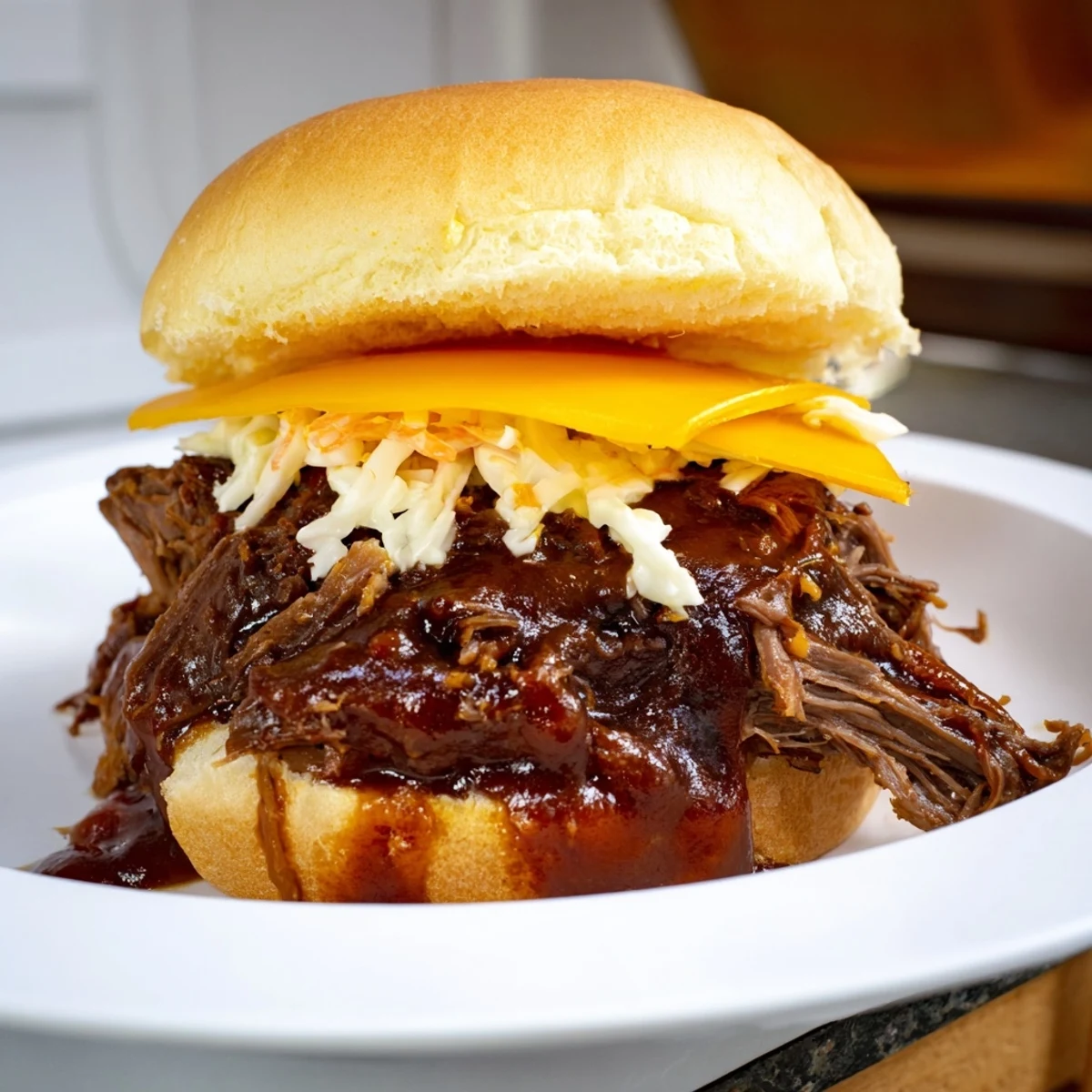 Golden-brown, slow-cooked beef brisket piled high on toasted mini brioche buns, drizzled with tangy homemade barbecue sauce for a messy, delicious bite.