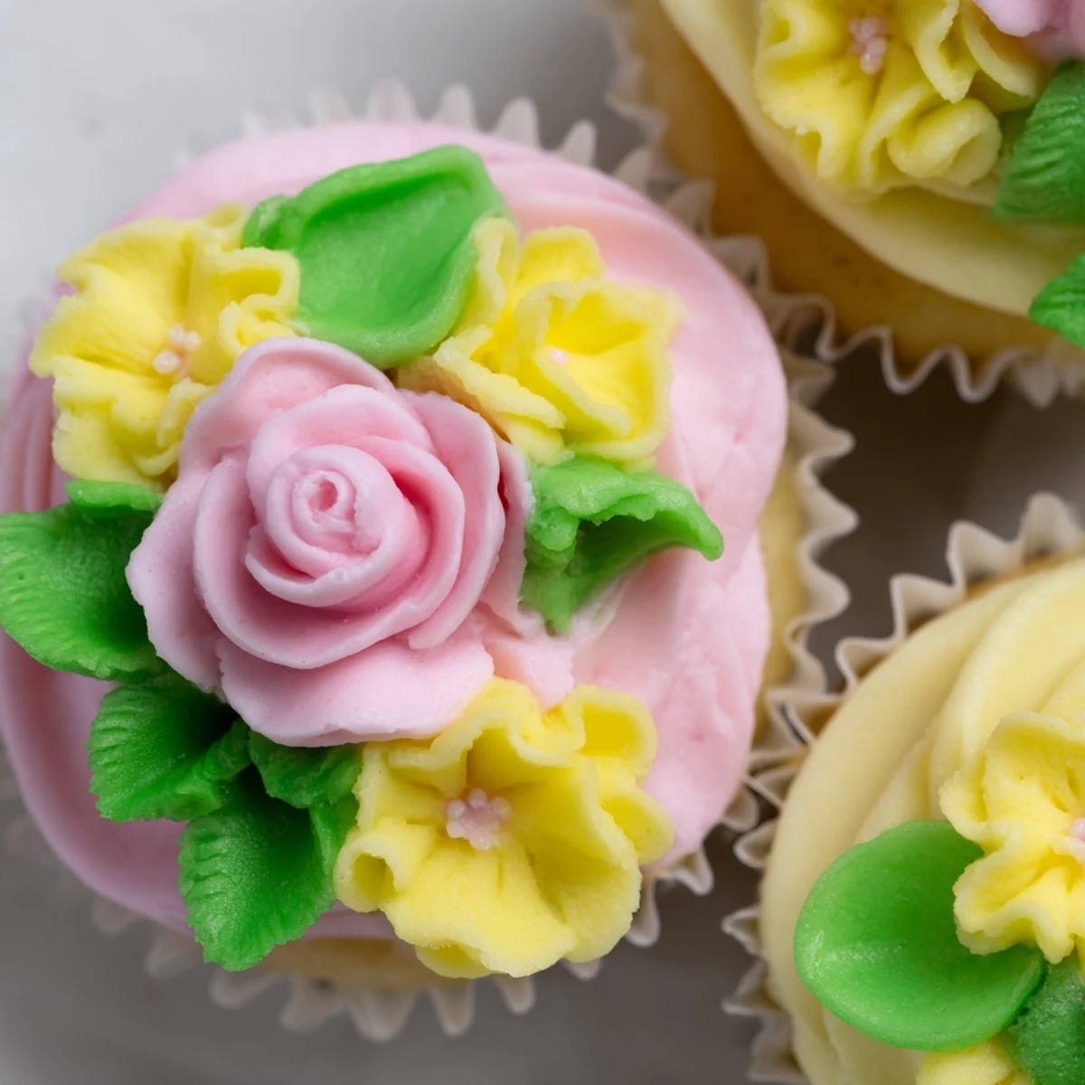 Delicate vanilla cupcakes with floral buttercream for a spring baby shower celebration.