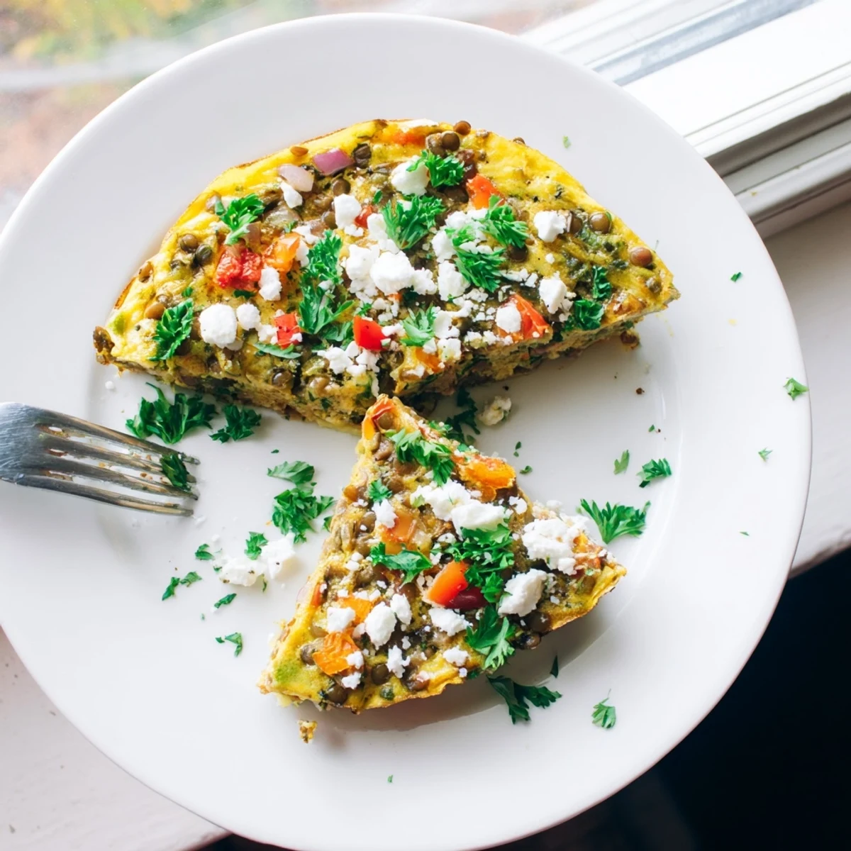 Healthy Lentil and Feta Frittata garnished with parsley, ideal for a Mediterranean-inspired vegetarian brunch or dinner.