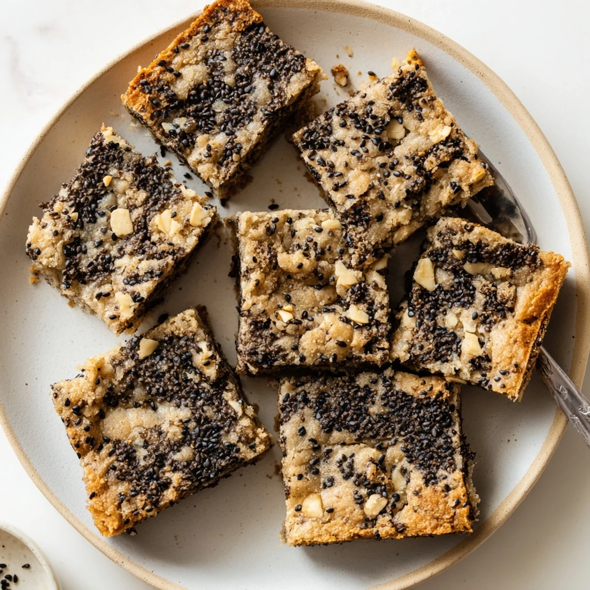 Buttery black sesame blondies fresh from the pan with white chocolate chips.