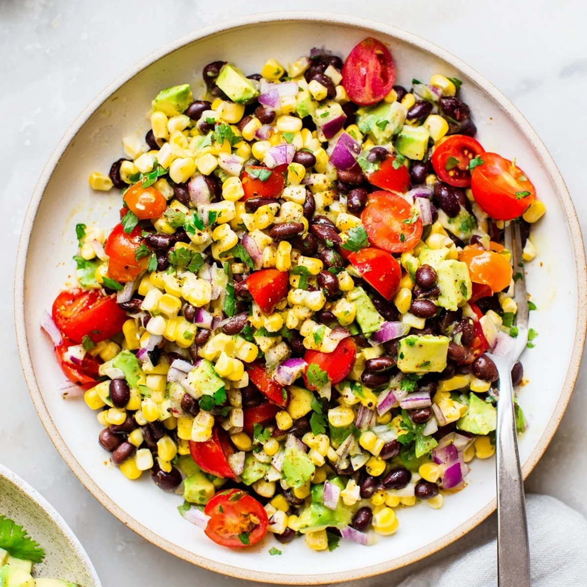 Vibrant Tex-Mex corn and black bean salad with red bell pepper and zesty lime dressing