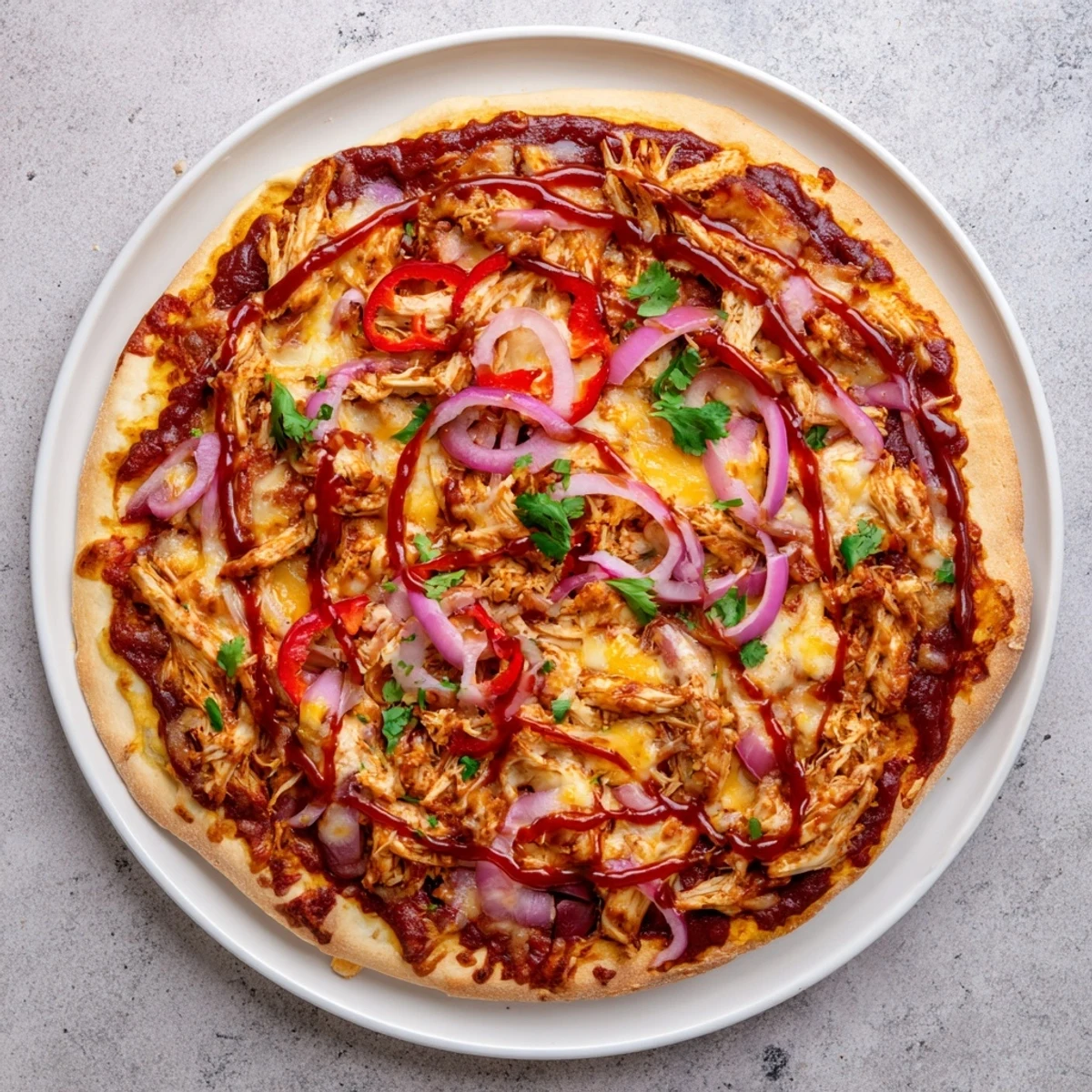 Savory BBQ chicken pizza featuring smoky sauce, melted mozzarella, and crisp red bell peppers
