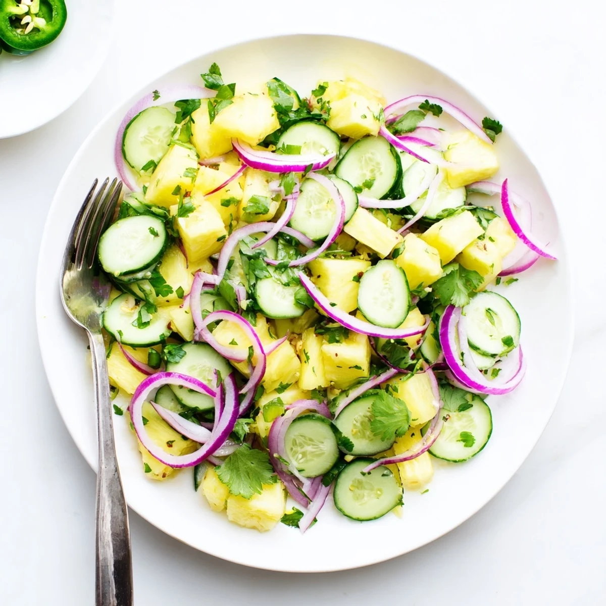 Colorful pineapple cucumber salad featuring crisp produce, red onion, and tangy lime dressing