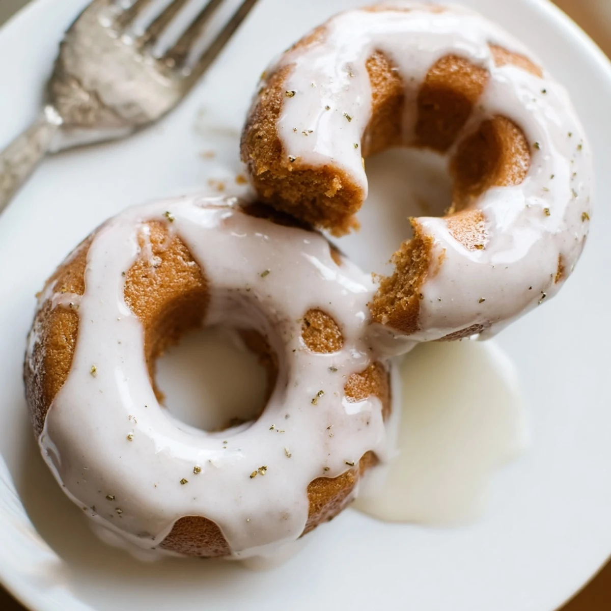Close-up of bite-sized Earl Grey mochi donuts dusted with tea leaves and glossy icing