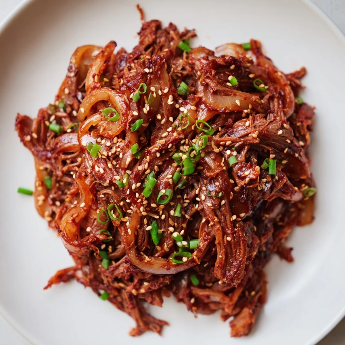 Tender slow cooker Korean beef with rich glazed sauce over fluffy white rice