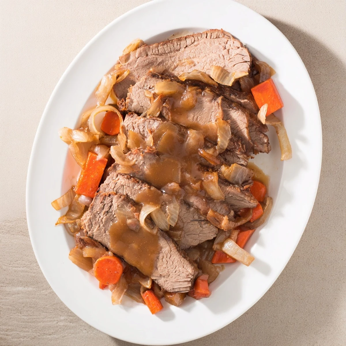 Fork-tender slow cooker beef brisket resting on a platter with roasted vegetables and glossy dark gravy
