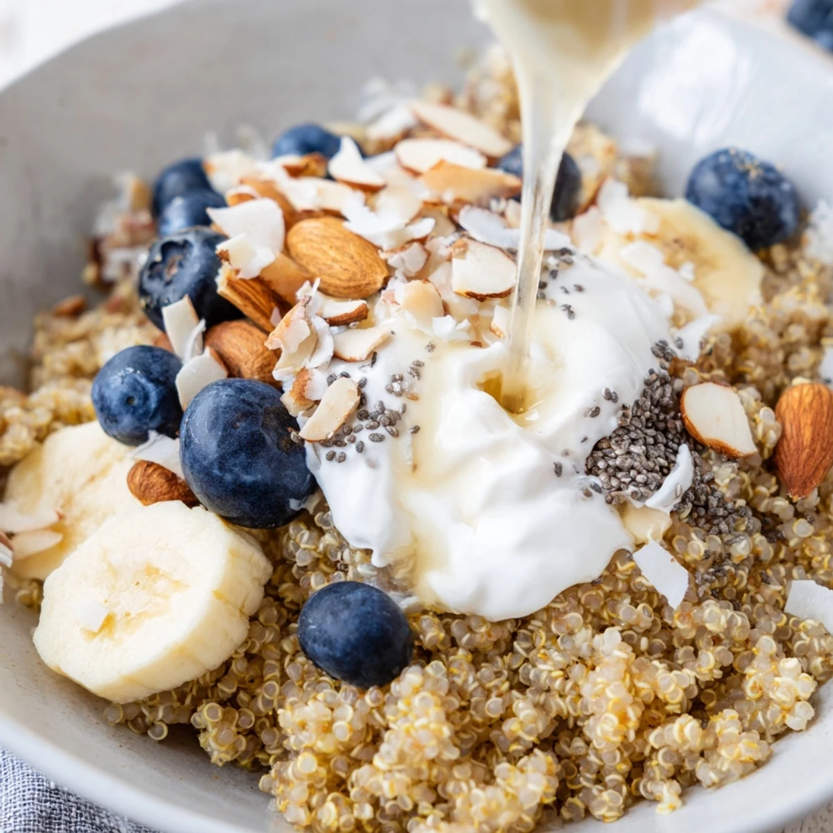Vibrant blueberry quinoa breakfast bowl featuring fluffy quinoa, colorful blueberries and nutritious nut toppings