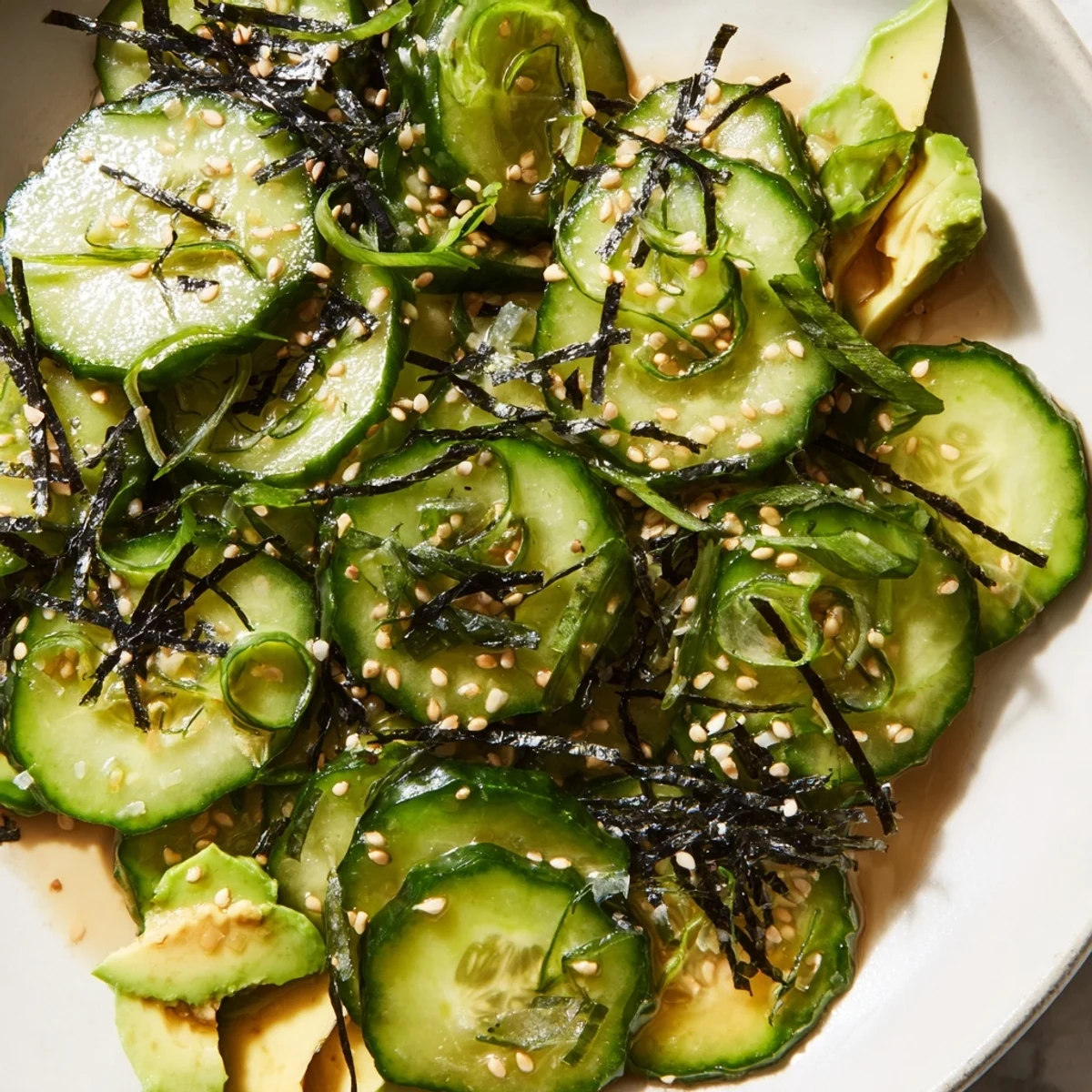Crisp sushi cucumber salad glistening with tangy rice vinegar dressing and toasted sesame seeds