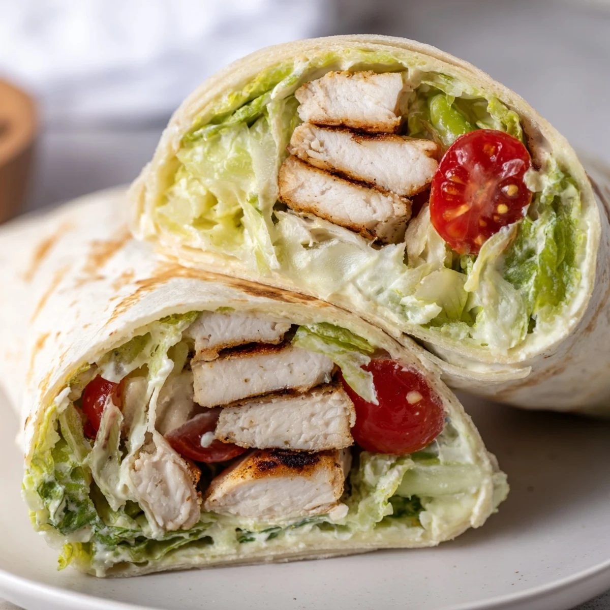 Golden grilled chicken Caesar wraps with crisp romaine and parmesan in a soft tortilla.