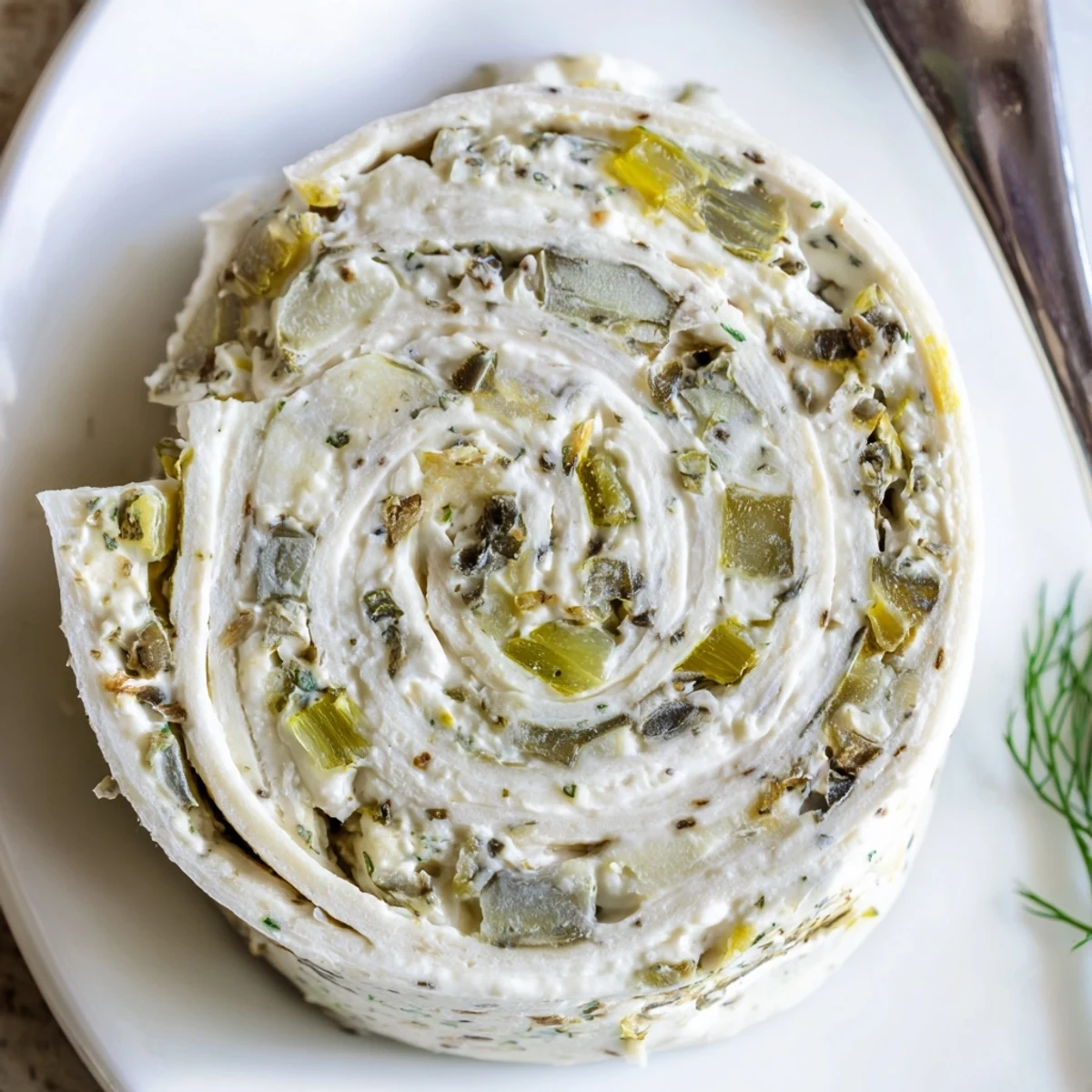 Stacked Pickle Dip Pinwheels sliced tightly, soft tortillas with tangy dill.