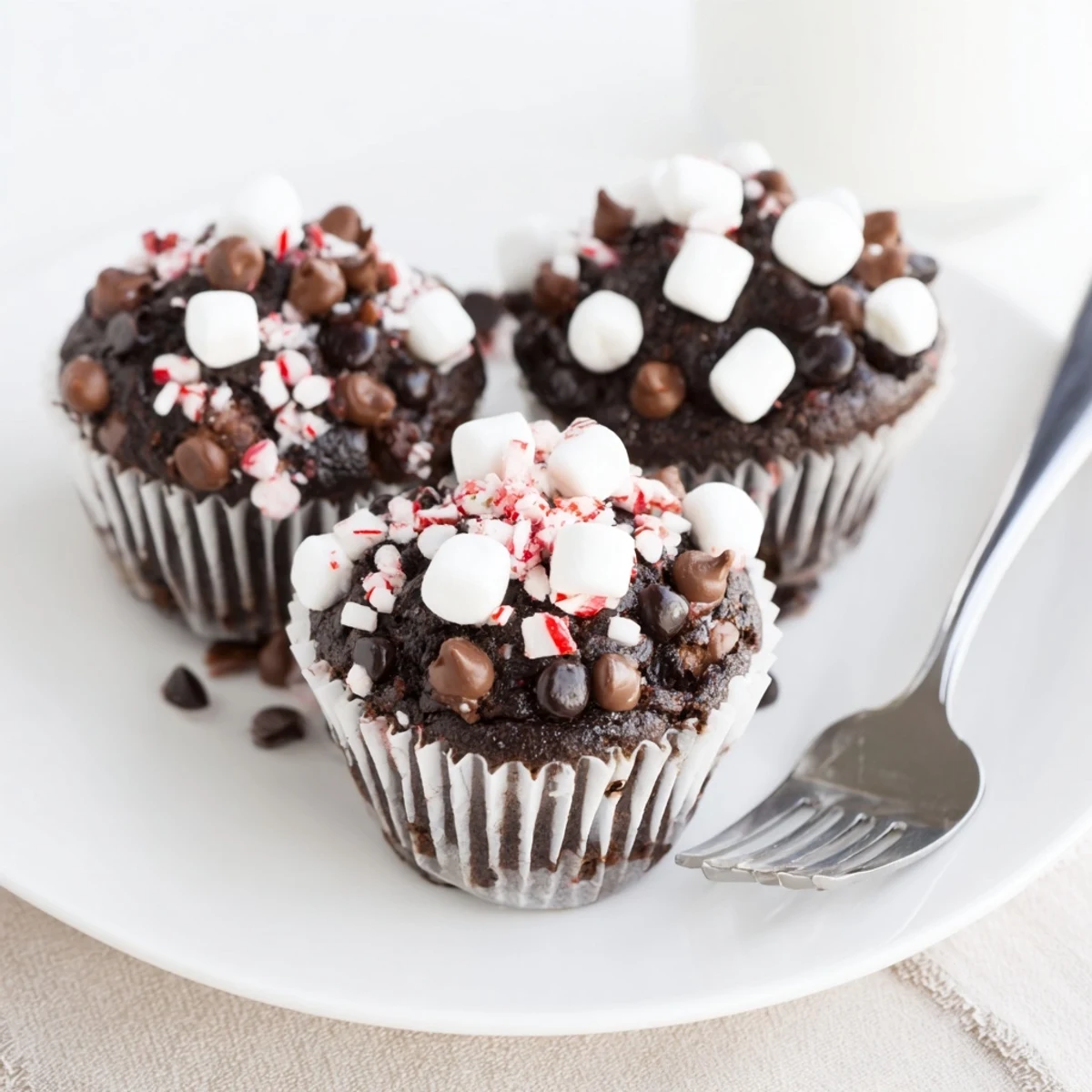 Peppermint Hot Chocolate Muffins glistening with crushed candy, warm and chocolatey aroma  