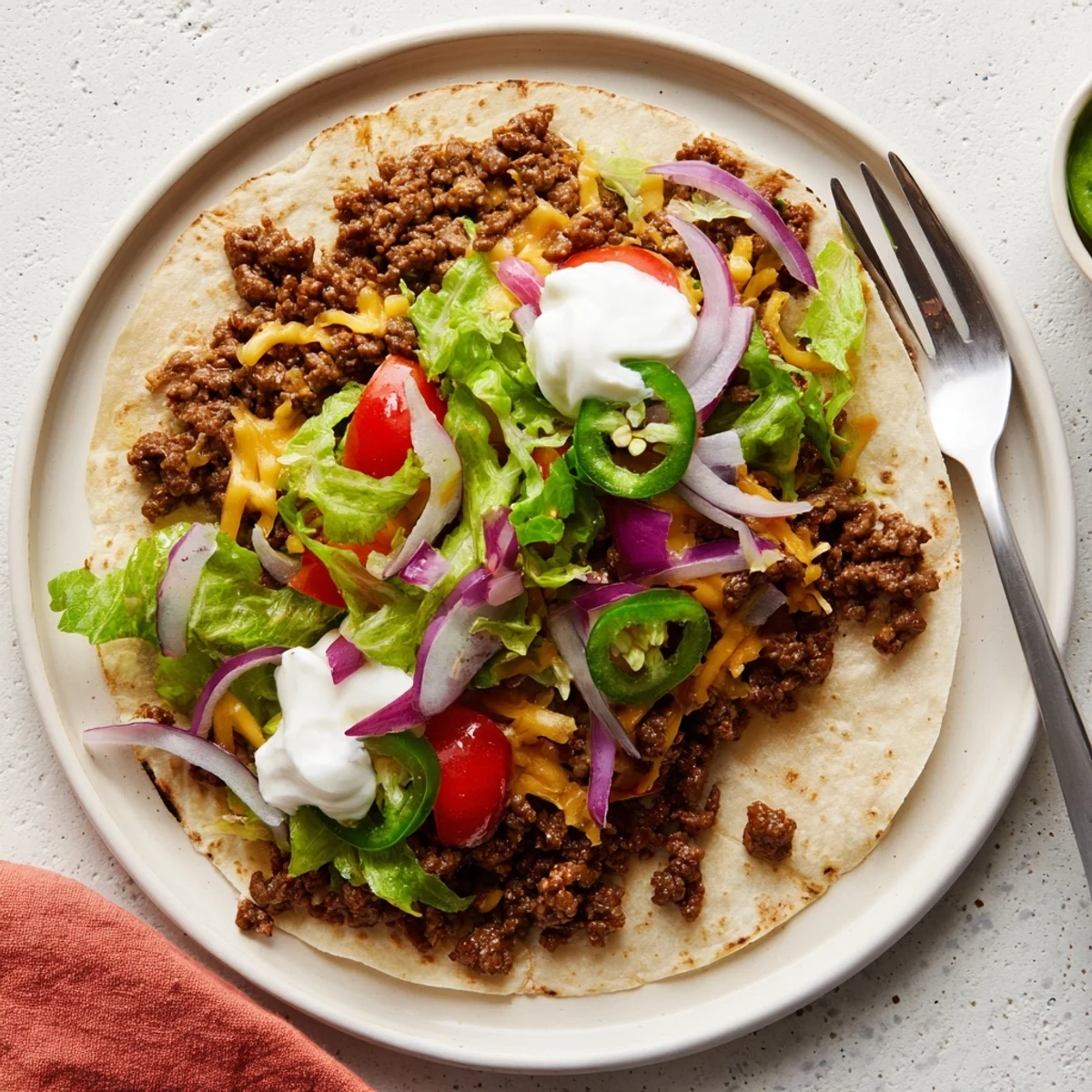 Sizzling smash burger tacos featuring juicy seasoned beef and bubbling cheese layers on a hot griddle