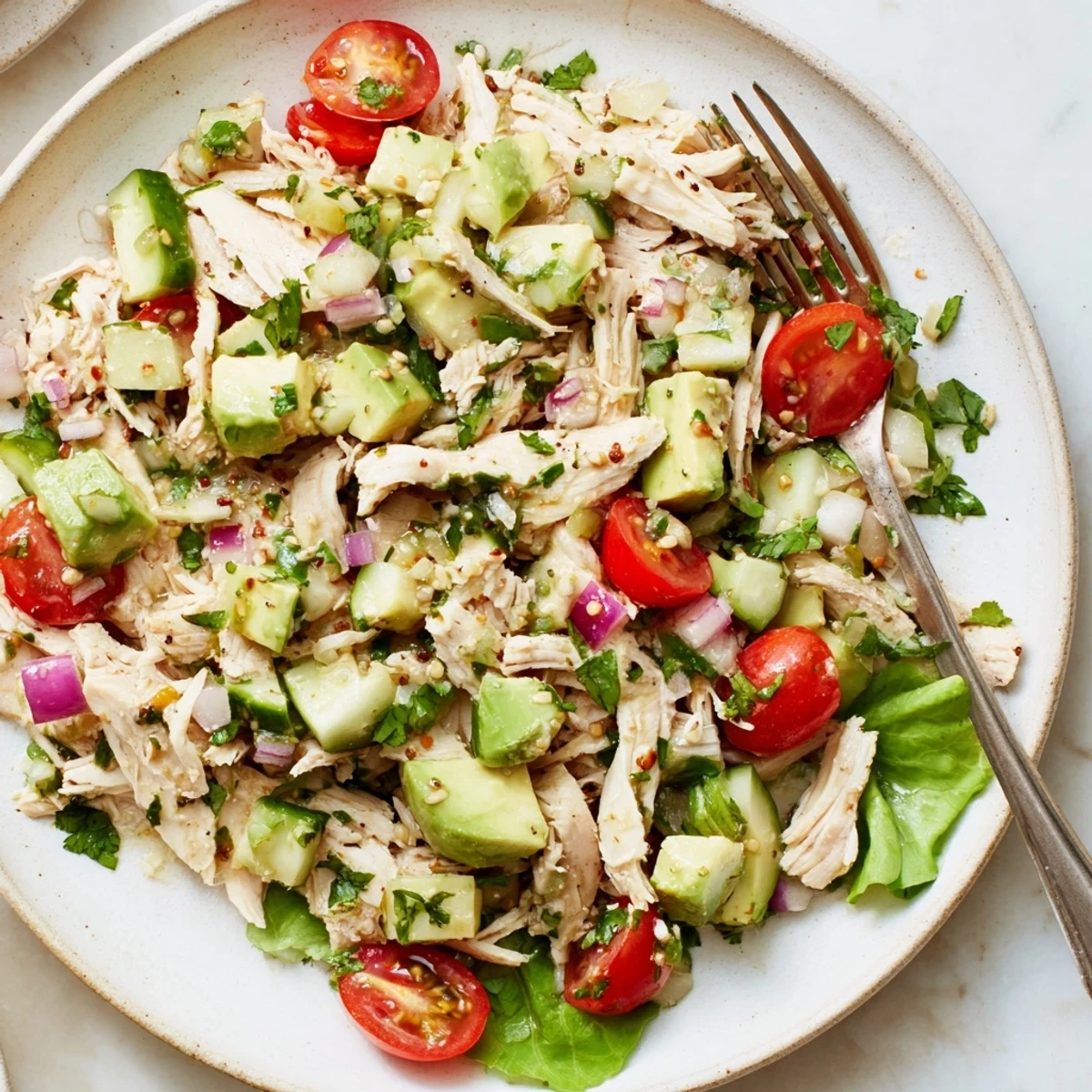 Hearty bowl of Avocado Chicken Salad with tender chicken, crunchy cucumber