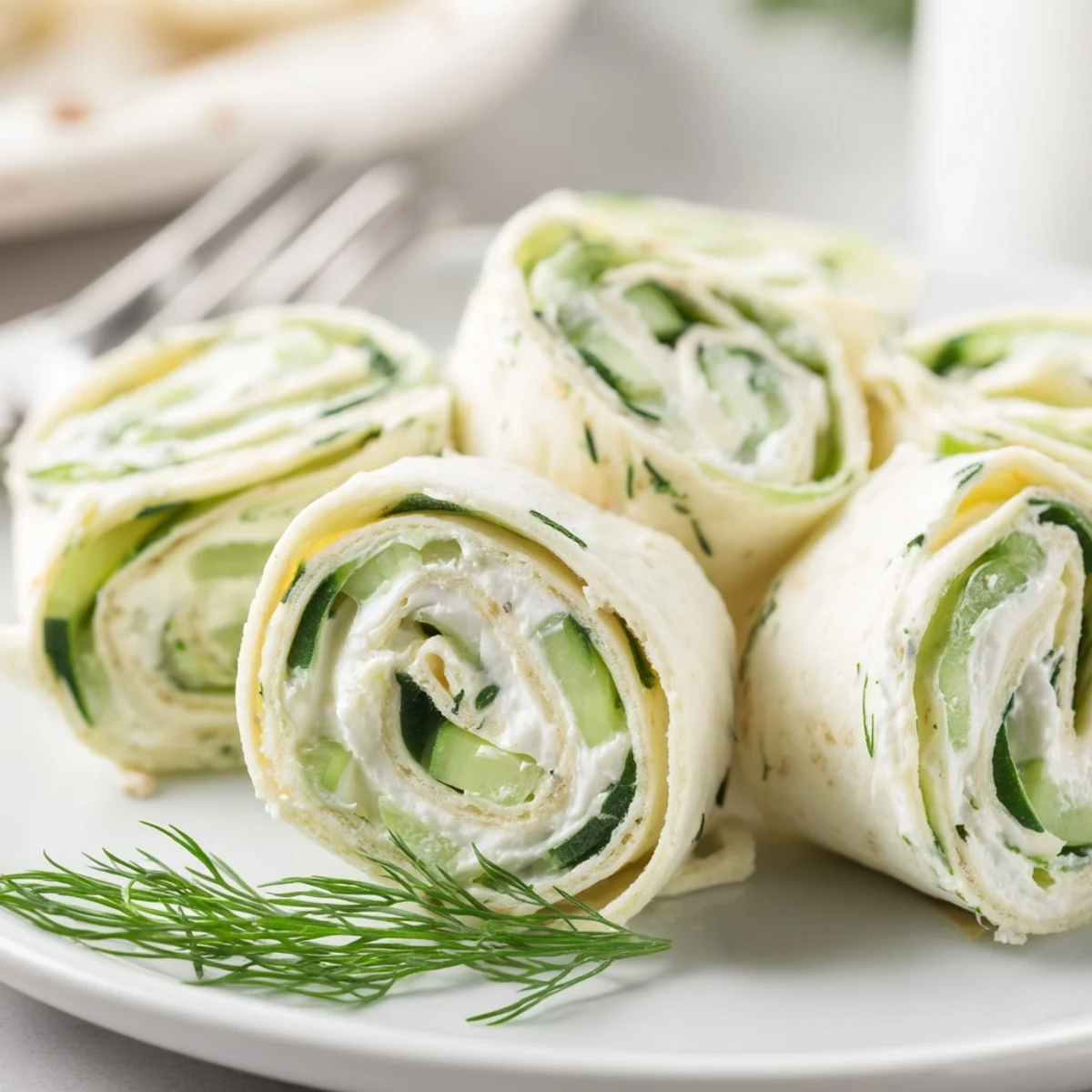 Bright Cucumber And Dill Pinwheels sliced bite sized, crisp cucumber, lemony cream cheese.