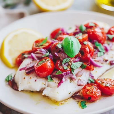 Tender Baked Halibut with Tomato and Basil Relish topped with diced tomatoes and balsamic glaze.