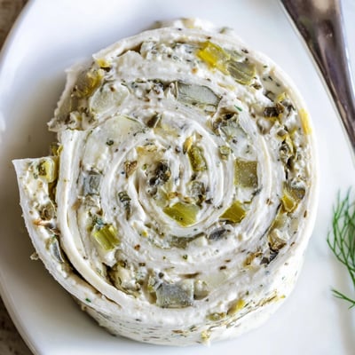 Stacked Pickle Dip Pinwheels sliced tightly, soft tortillas with tangy dill.