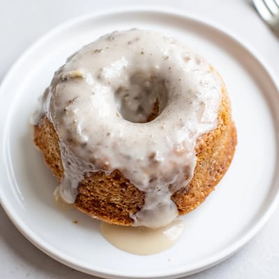 Glazed Banana Donuts stacked on a plate, sweet vanilla aroma inviting