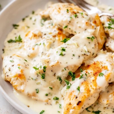 Tender cream cheese chicken smothered in a silky Parmesan sauce with fresh chives